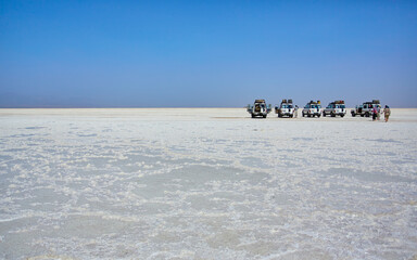Scorching Lake Asale and four-wheel drive vehicles, Danakil lowlands, Ethiopia © nekoandcoro