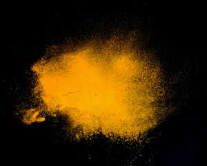 Fototapeta na wymiar Powder explosion isolated on Dark background. dust particles splash. Powder Explosion dust explodes Holy Festival.