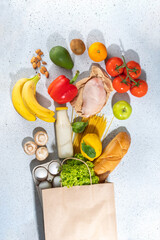 Fresh vegetables, meat, bread fruits in paper grocery bag. Delivery healthy food background....