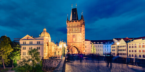 Naklejka na ściany i meble Amazing night view of Charles bridge on Vltava river (Karluv Most) with statues and Prague castle. Illuminated evening cityscape in Prague, Czech Republic, Europe. Architecture traveling background..