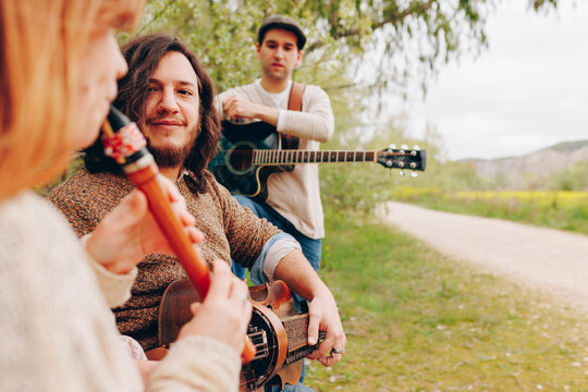 Musicians with musical instruments near roadside