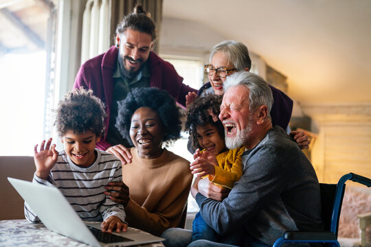 Extended multiethnic family together at home during video call. People happiness technology concept