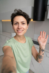Smiling woman taking selfie at home