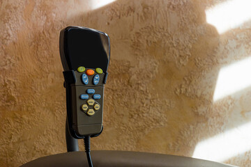 Remote control of contemporary massage chair in rehab room