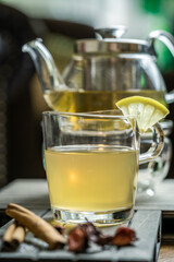Tea in a glass with bottle and slice of lemon
