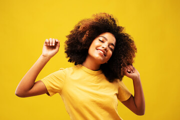 young african woman portrait with big afro curly hair dancing and with hairstyle flying in air