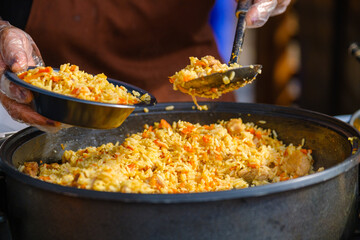 Crop cook serving delicious pilaf