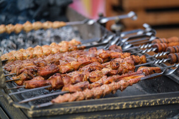 Skewers grilling on brazier outside restaurant