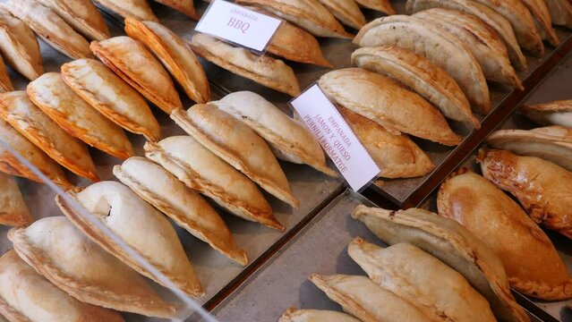 Spanish cuisine dish, empanadas, stacked on market stall