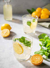 Lemonade soda drink with fresh lemons. Refreshing cocktail with lemon, mint and ice. Summer cold drinks concept