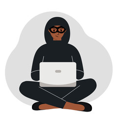 Hacker in a black mask with a computer. The cybercriminal is holding a laptop. Cyber attack, mobile phishing, scam.