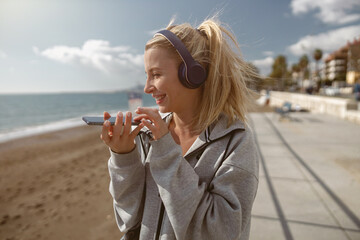 Model listening to music during exercising near sea