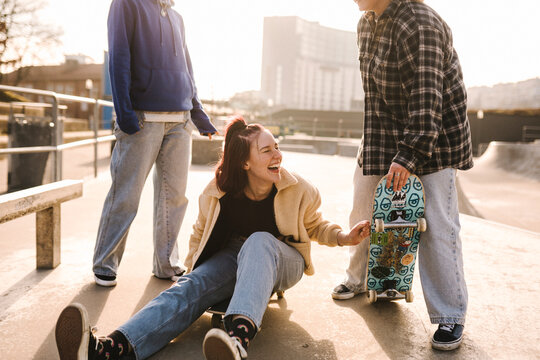 Laughing teenage girls in skatepark