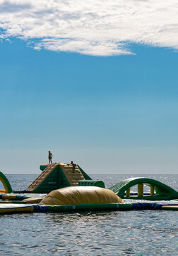 Inflatable waterpark with kids on Mediterranean Sea.