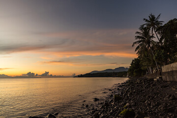 Fototapeta na wymiar Palm trees against sunrise sea view in Bali, Indonesia