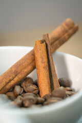 Cinnamon sticks in fresh coffee beans