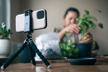 Woman vlogging about potted plants