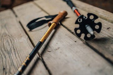 Close up detail photo of trekking poles on wooden background. Hiking telescopic poles. Nordic...