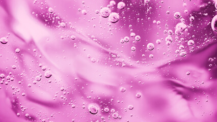 Close up macro Aloe vera gel cosmetic texture pink background with bubbles. Lemongrass gel skincare product. antibacterial liquid with aloe vera, moisturizing. Safe and environmental friendly.