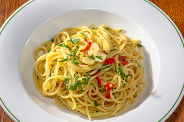 Vegetarian Italian Pasta Spaghetti Aglio E Olio with garlic bread, red chili flake, parsley, parmesan cheese.