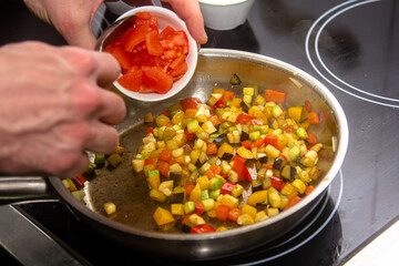 Sprinkling ground red chili pepper paprika over sliced vegetables, motion blur