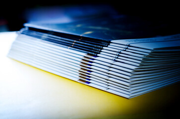stack of magazines on yellow background, isolated