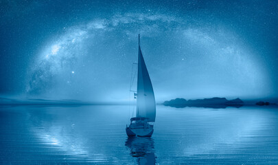 Lone sailing luxur yacht under starry night sky with Milky Way galaxy
