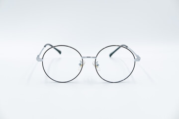 Isolated white background, Selective focus round eyeglasses with silver rim.