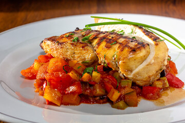 Grilled chicken meat and fresh vegetable salad of tomato, avocado, lettuce and spinach. Healthy and detox food concept. Ketogenic diet.