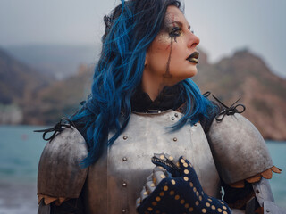 Medieval knight woman in armor prays, blessing before the battle.