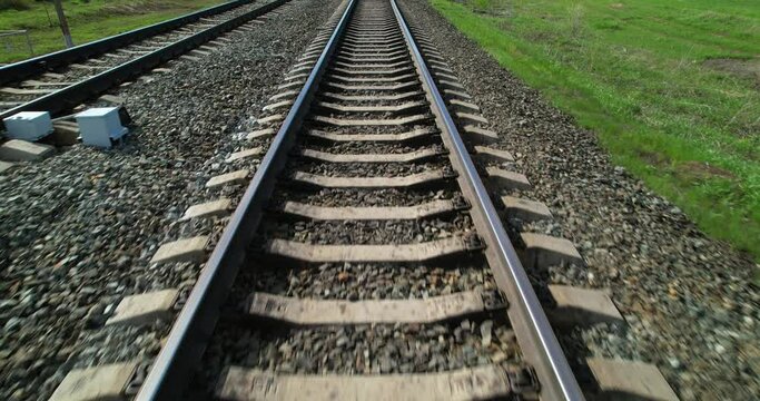 Railway track view in motion. Rails for trains. Railway track in the direction of travel first-person view.