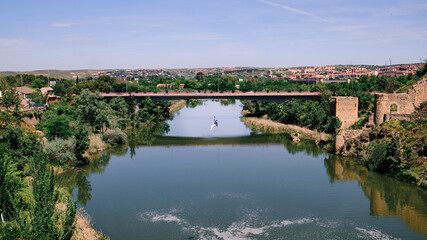 Fototapeta premium Person jumping on a zip line across the Tajo river in Toledo