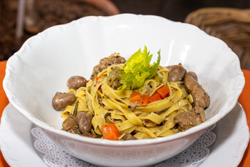 Italian linguini pasta with chicken hearts and herbs