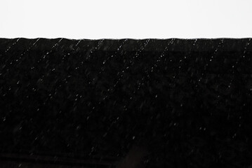 Abstract black and white contract geometric nature background with water drops flow and fall as diagonal stripes from roof. Modern abstract composition of calm and melancholy.