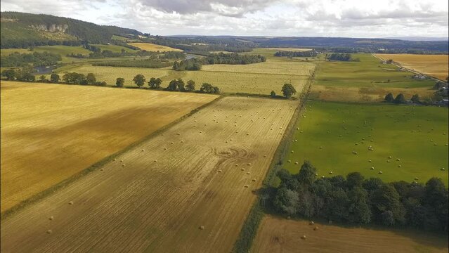 Hay Bale Fields in Scotland on Overcast Midday Aerial View Dolly in