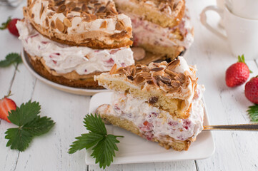 Slice of cream cake with strawberries and meringue topping