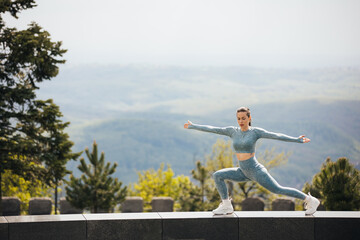 Portrait of beautiful fit woman exercising in the park. Caucasian female fitness model working out in the morning.