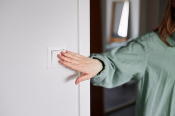 Hand pressing light switch