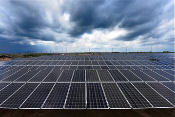 Photovoltaic modules solar power plant on dramatic sky background - Green alternative power energy concept to reduce global warming and climate change