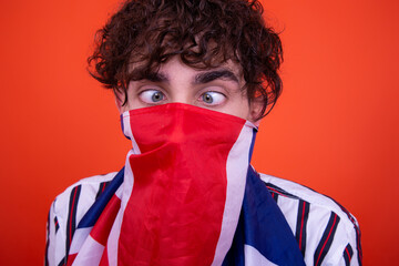 Young attractive guy with a flag posing in the studio.