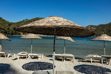Beach umbrellas in Oludeniz at sunny day, Turkey.