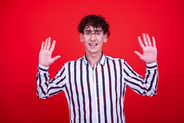 Naklejka premium Emotions of a young attractive guy. Orange background.
