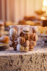 Sweet macarons in a plastic  jars on a candy bar.