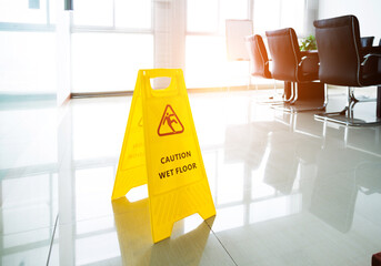 Wet floor caution sign in office