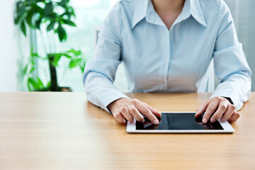 Close up young woman using digital tablet