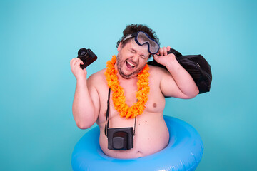 Vacation and holidays. Funny fat man is going to the sea. © vladorlov