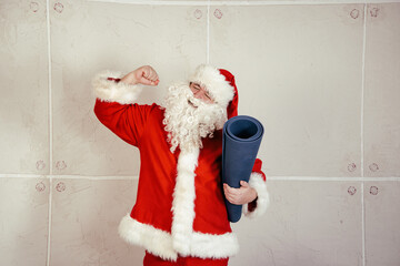 Funny fat Santa Claus goes in for sports at home.