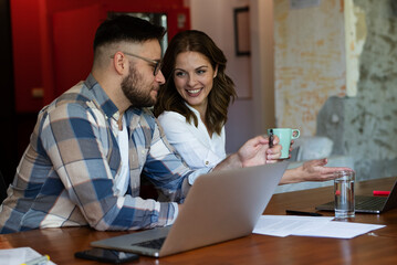 Colleagues in office. Businesswoman and businessman discussing work in office