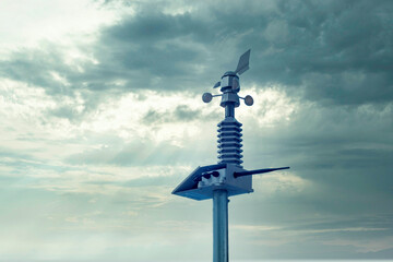 Automatic weather station, with a weather monitoring system. Against the background of a gray sky...