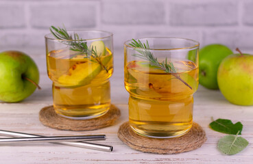 Apple juice from green apples on a white wooden background